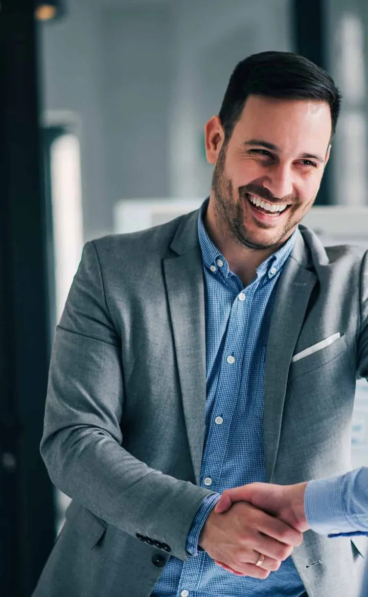 Two businessmen shaking hands in an office